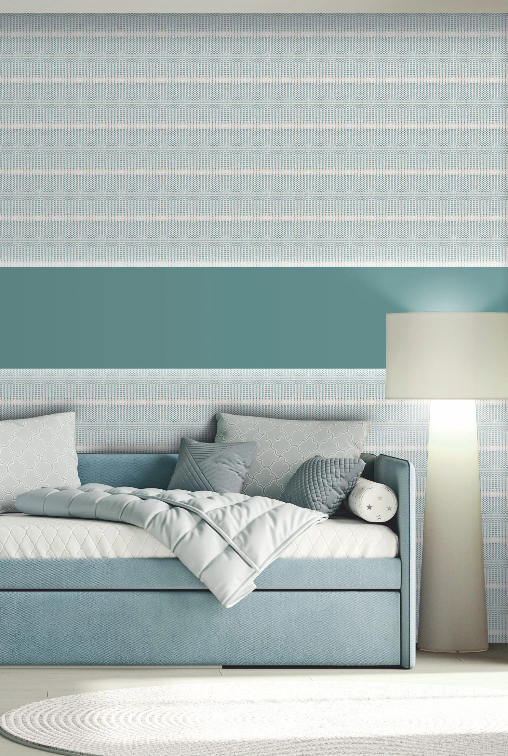 Light blue sofa with cushions and a throw blanket against a striped wallpapered wall with a floor lamp.
