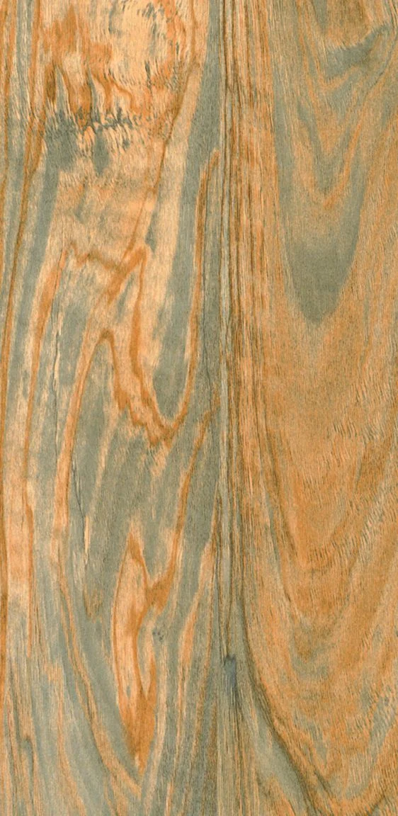 Close-up of light brown and grey swirling wood grain patterns.