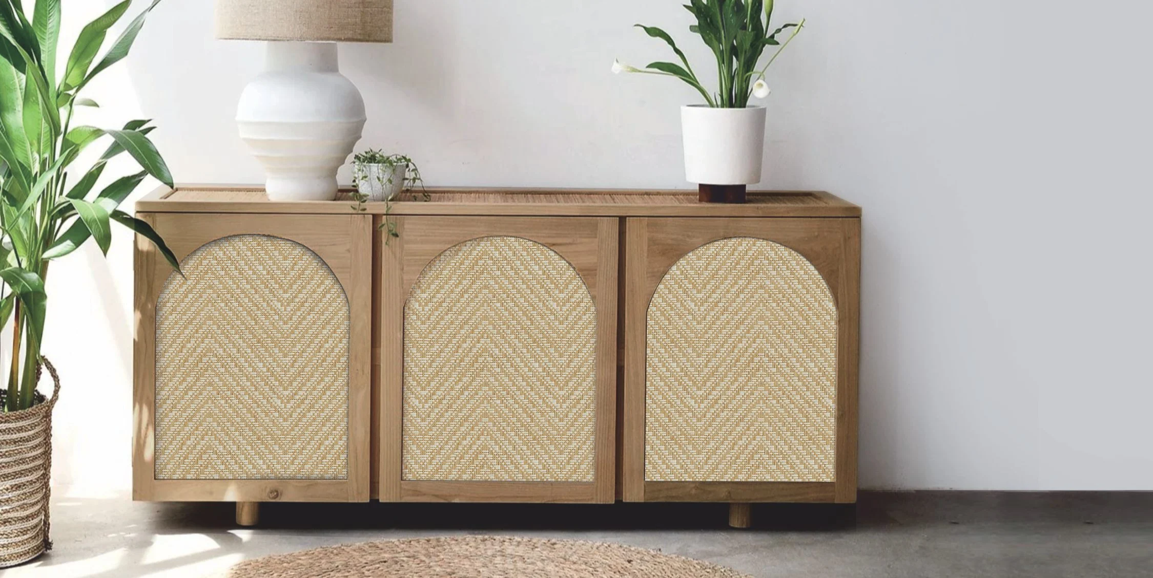 Wooden sideboard with three arched woven rattan panels.