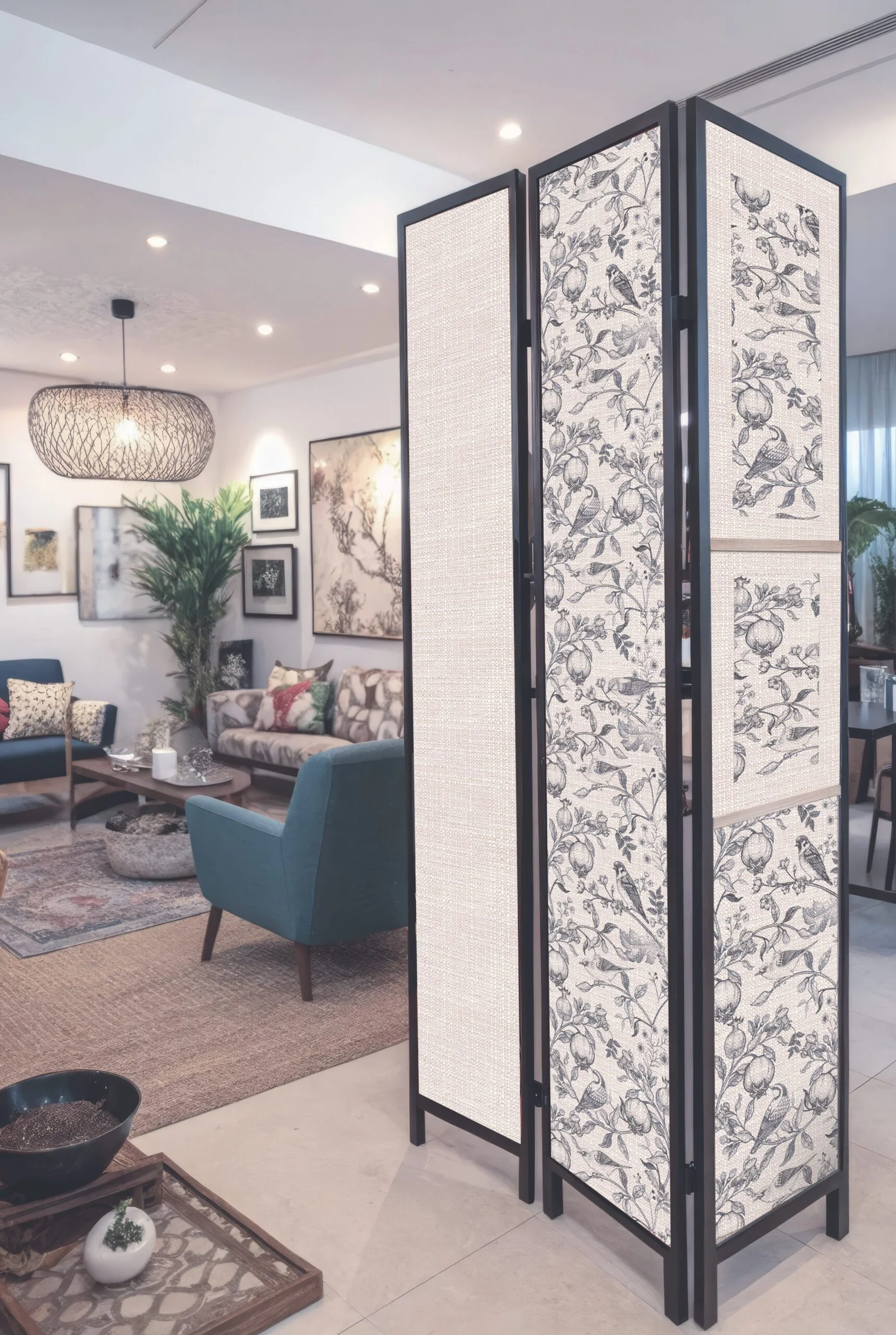 Three-panel room divider with black frames and floral fabric inserts in a modern living room.