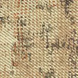 Close-up of beige textured fabric with irregular dark brown and orange speckled patterns.